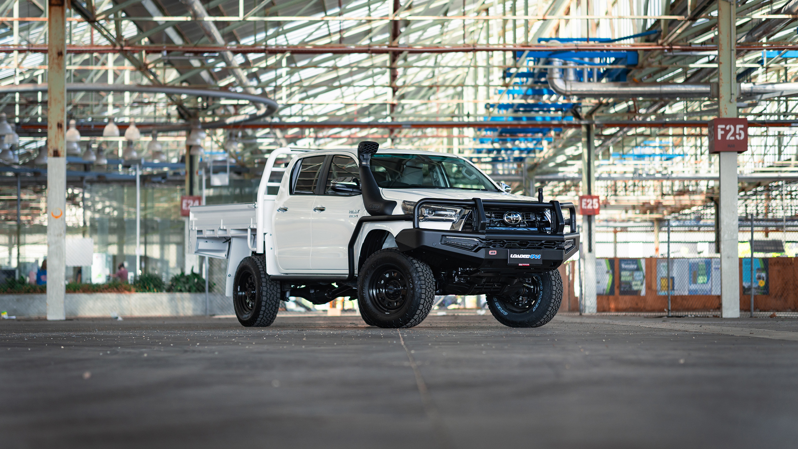 Ranger AT steel wheels on white Toyota HiLux inside industrial factory Ranger AT steel wheels on white Toyota HiLux inside industrial factory