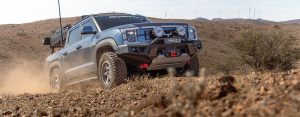 CSA-X Sandstorm machined wheels fitted to BYD Shark 6 ascending dry rocky hill off track header