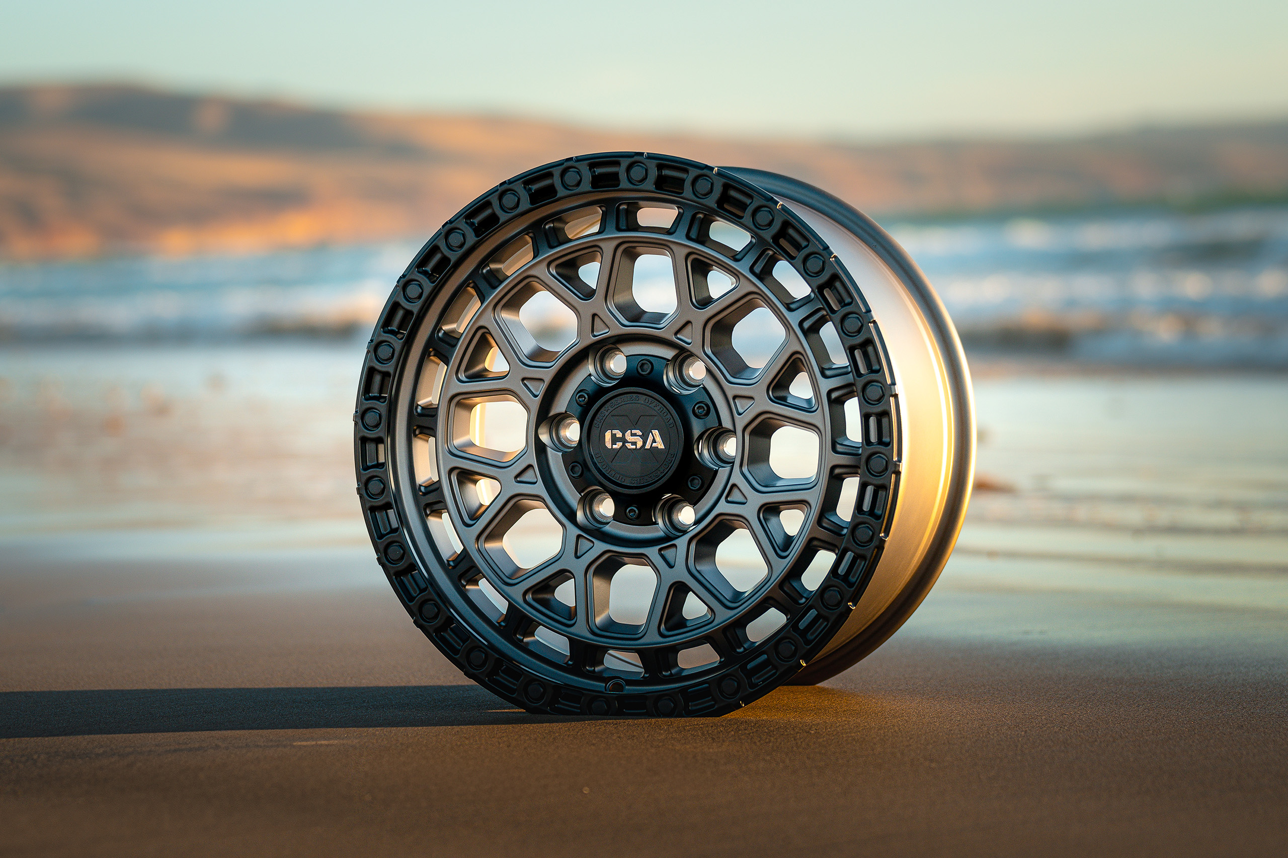 CSA-X Thunder Satin grey wheel close up view on beach CSA-X Thunder Satin grey wheel close up view on beach