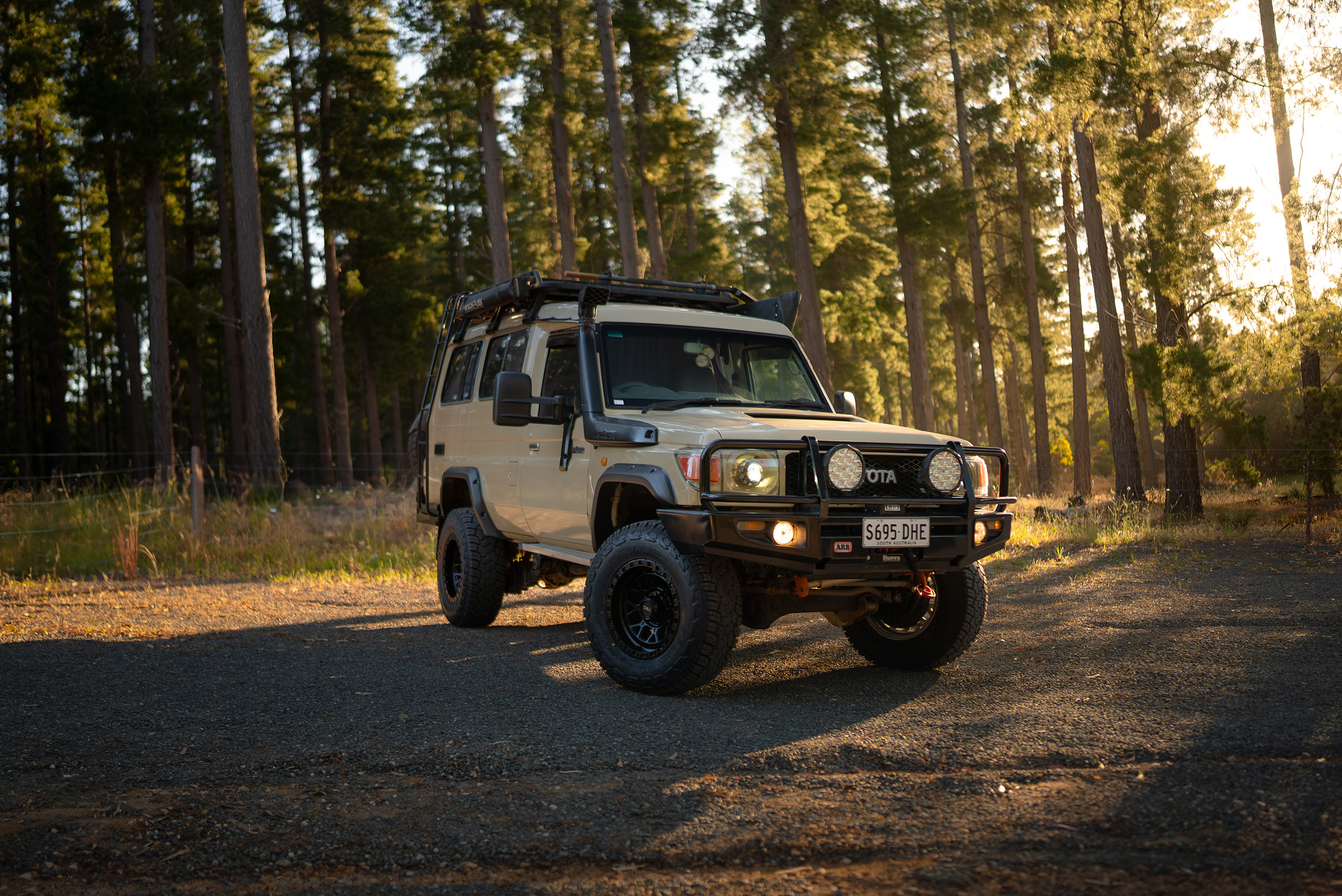 CSA Thunder deep black wheels on sandy LandCruiser 78 Series on gravel road in pine forest