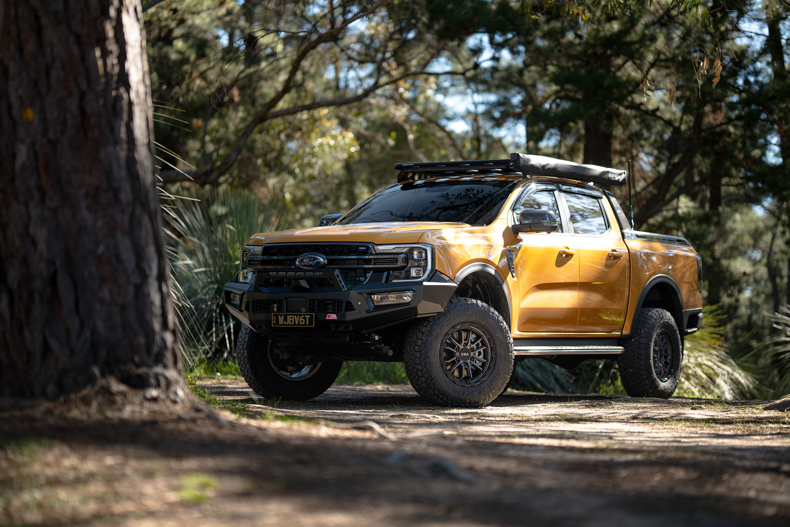 CSA Thor satin graphite wheel on gold Ford Ranger in the forest CSA Thor satin graphite wheel on gold Ford Ranger in the forest